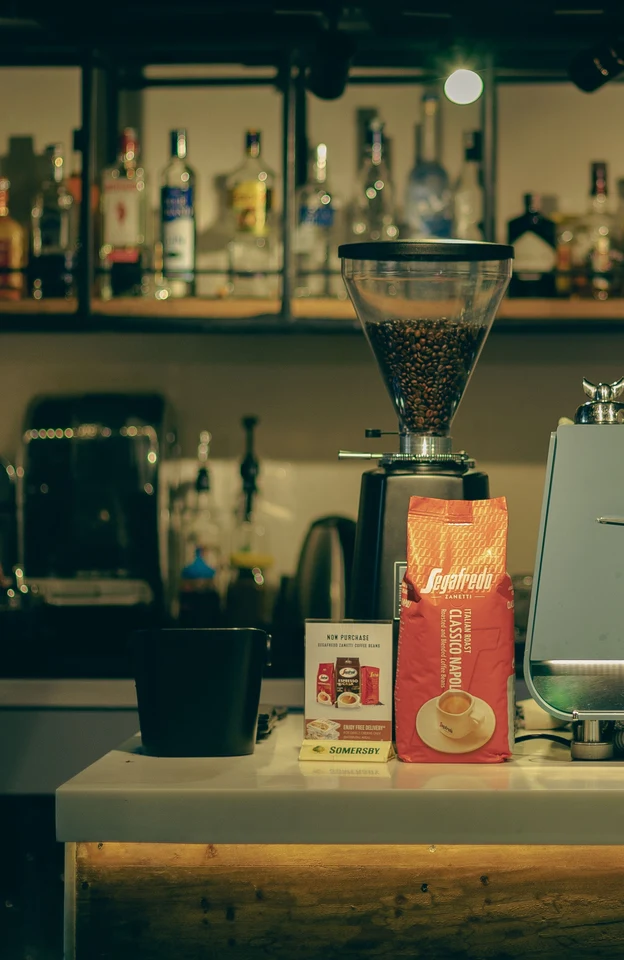 A café coffee station with beans and grinder