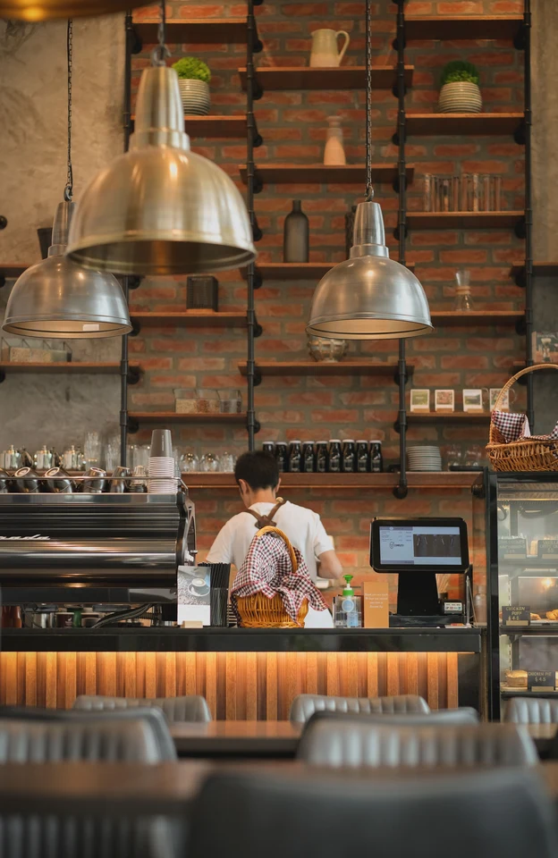 A barista serving at the café counter