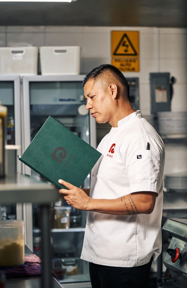 A chef checking stock by the walk-in in a cloud kitchen