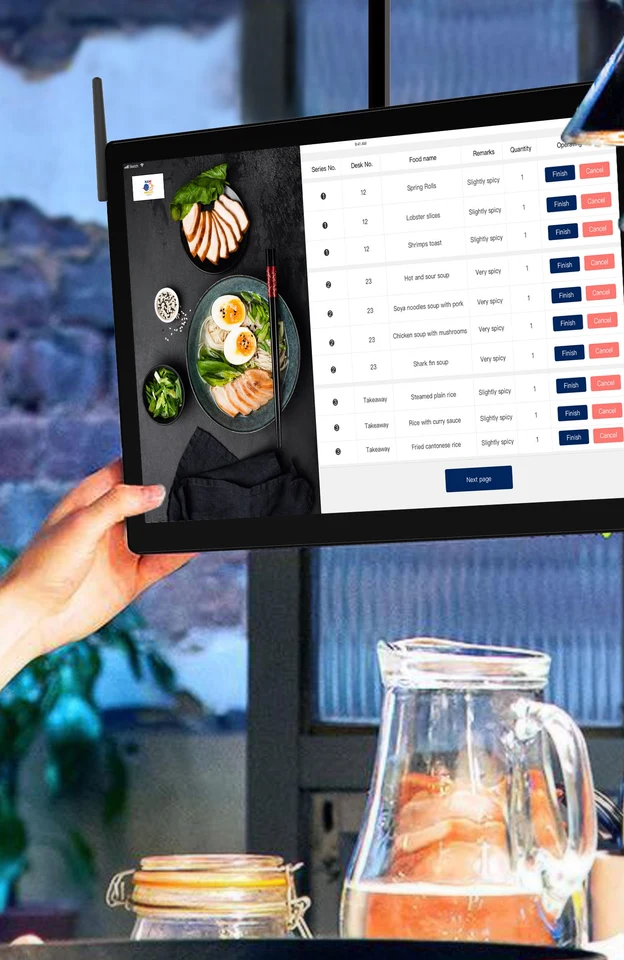 A cook working an order screen in a delivery kitchen