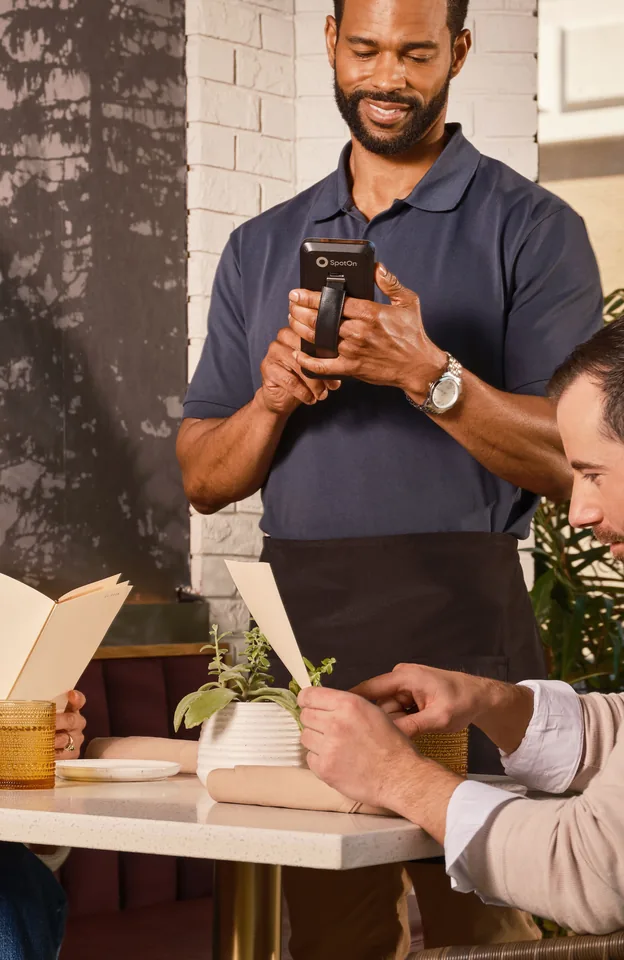 Staff taking an order on a handheld in the food court