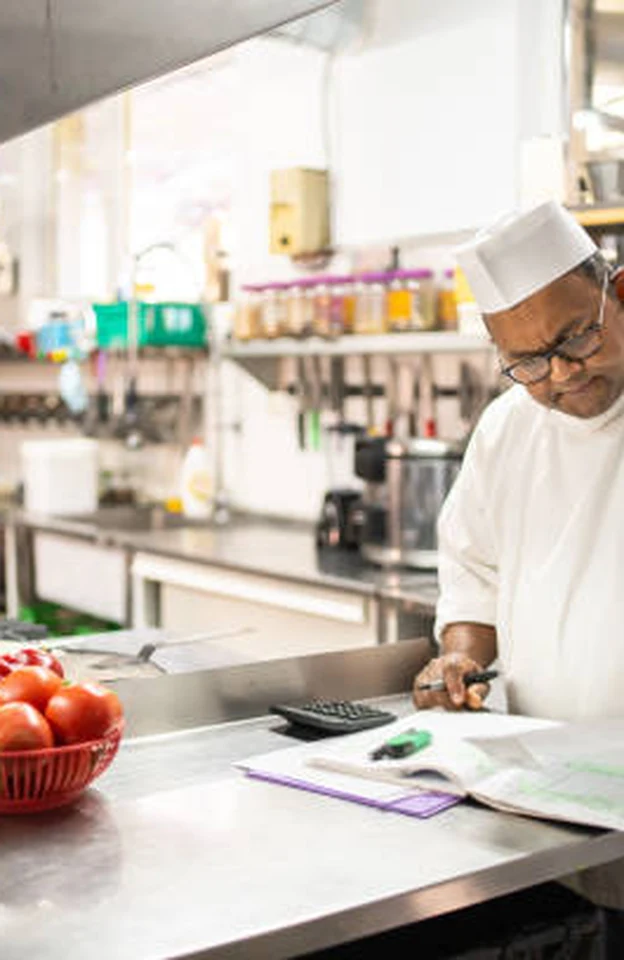 A hotel chef checking stock in the kitchen