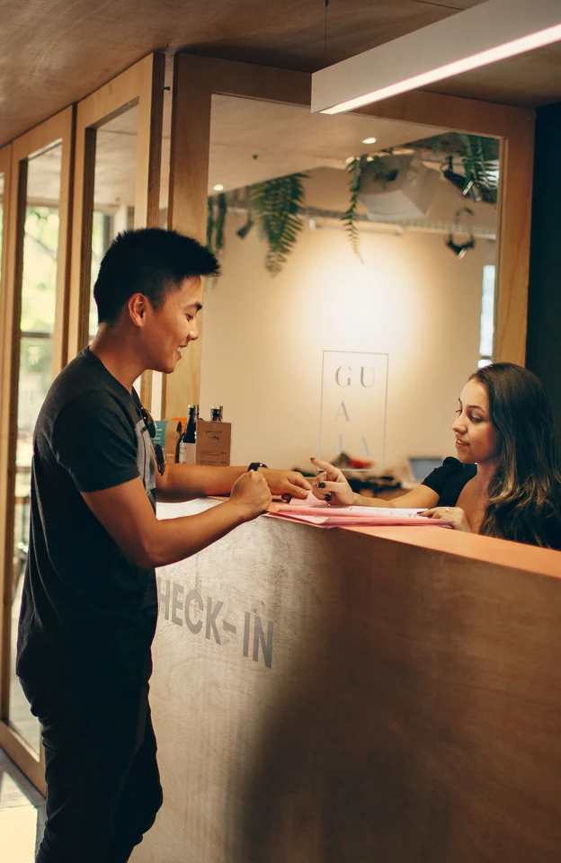 A guest checking in at a hotel reception desk