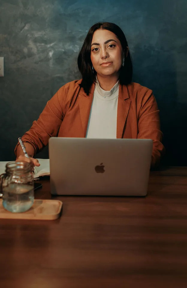 A restaurant owner reviewing the day's numbers on a laptop